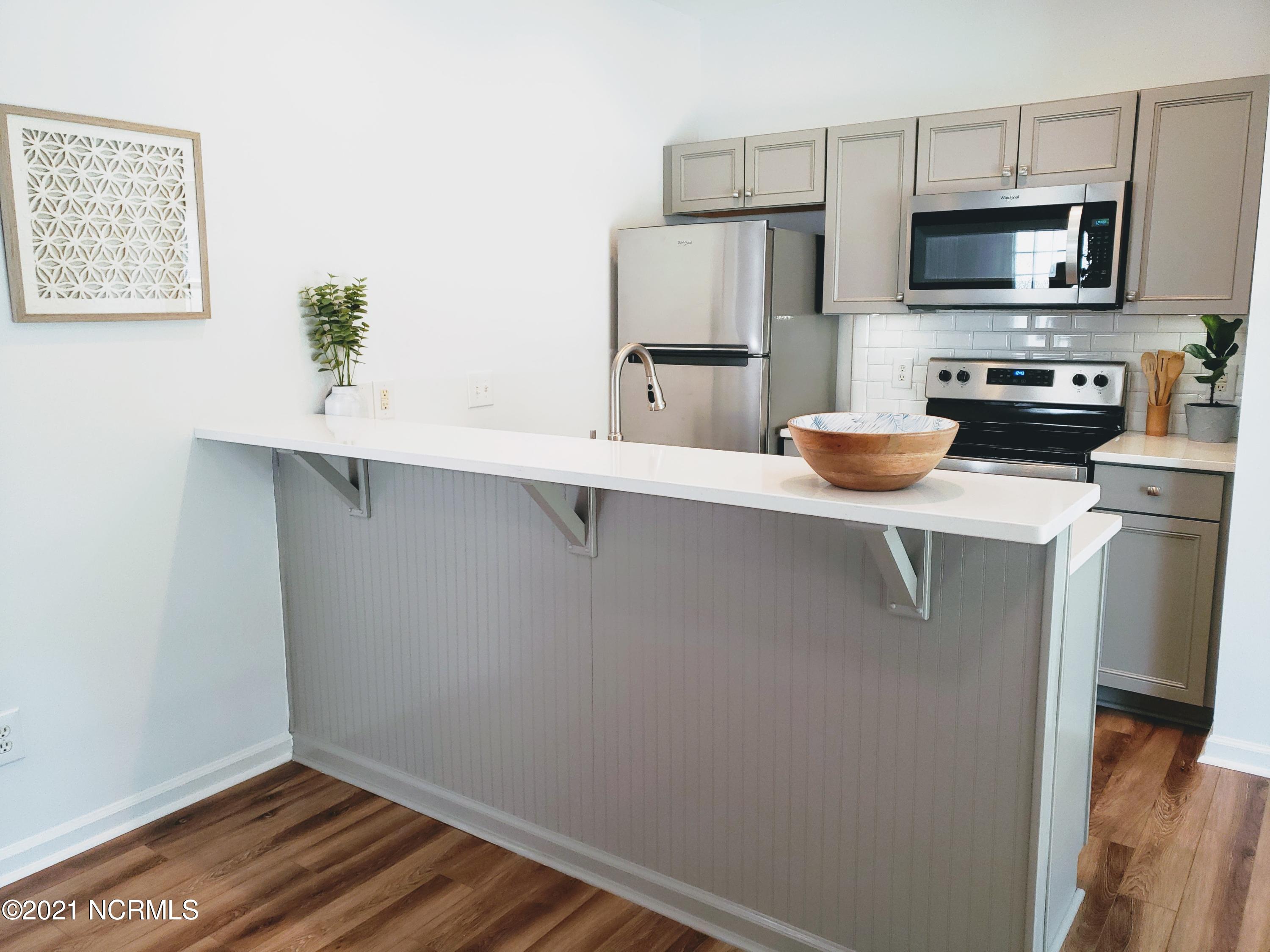 155 Royal Poste Road, Unit 3002 Sunset Beach, NC 28468 - Photo 4 of 20 Brand NEW Kitchen - Quartz countertops, Cabinets, Stainless Delta Faucet, double-bowl stainless sink, Stainless Whirlpool Refrigerator, Microwave, Dishwasher and Badger Garbage Disposal.