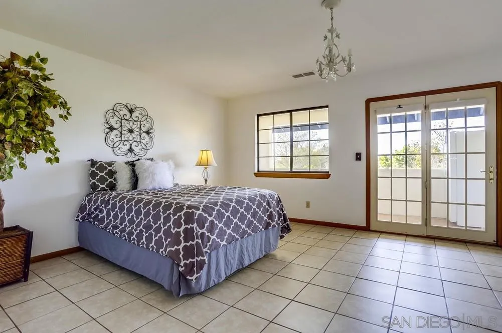 3690 Lupine Lane Fallbrook, CA 92028 - Photo 19 of 37 a bedroom with a bed and a window