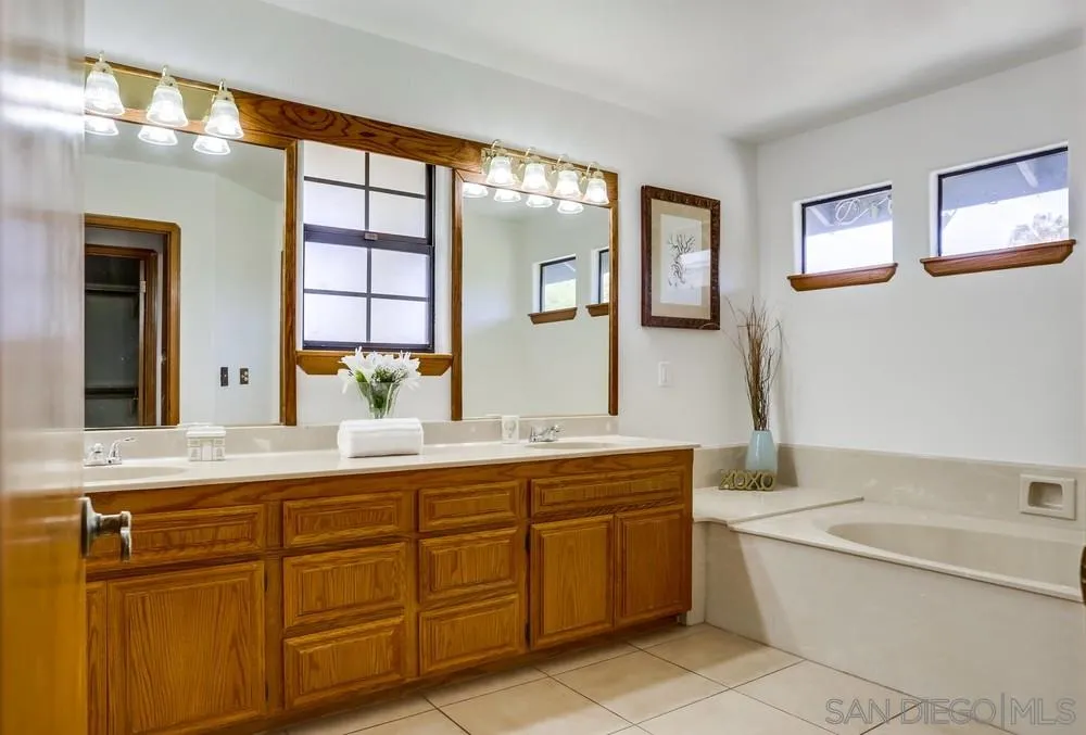 3690 Lupine Lane Fallbrook, CA 92028 - Photo 20 of 37 a bathroom with a granite countertop bathtub sink and mirror