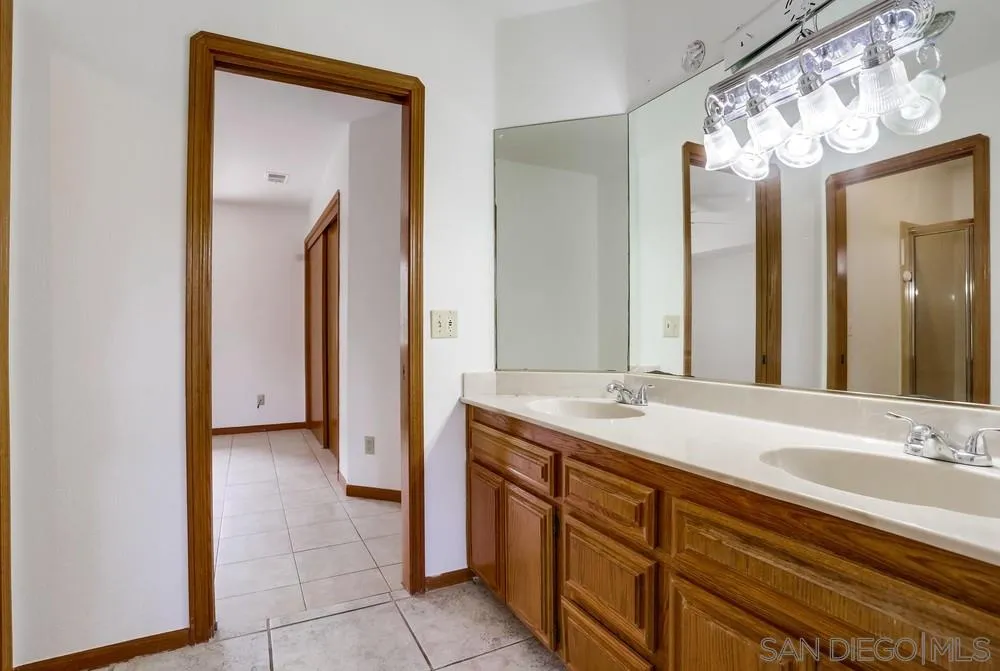 3690 Lupine Lane Fallbrook, CA 92028 - Photo 24 of 37 a bathroom with a granite countertop sink and a mirror