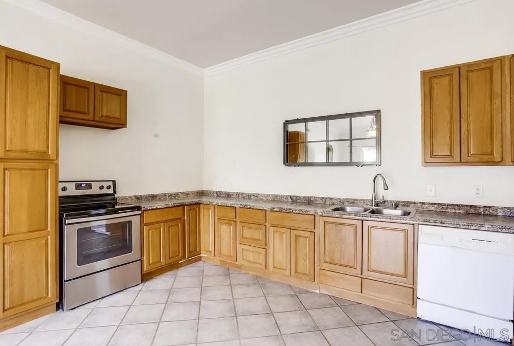3690 Lupine Lane Fallbrook, CA 92028 - Photo 28 of 37 a kitchen with stainless steel appliances granite countertop a sink and a stove top oven with white cabinets