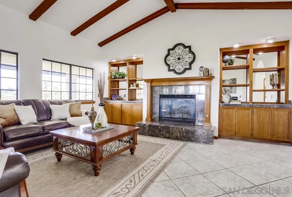 3690 Lupine Lane Fallbrook, CA 92028 - Photo 7 of 37 a living room with furniture a fireplace and a large window