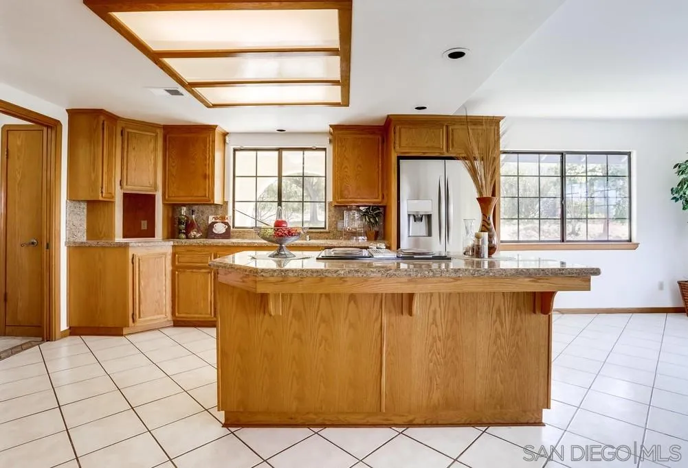 3690 Lupine Lane Fallbrook, CA 92028 - Photo 9 of 37 a kitchen with stainless steel appliances granite countertop a sink and a counter space