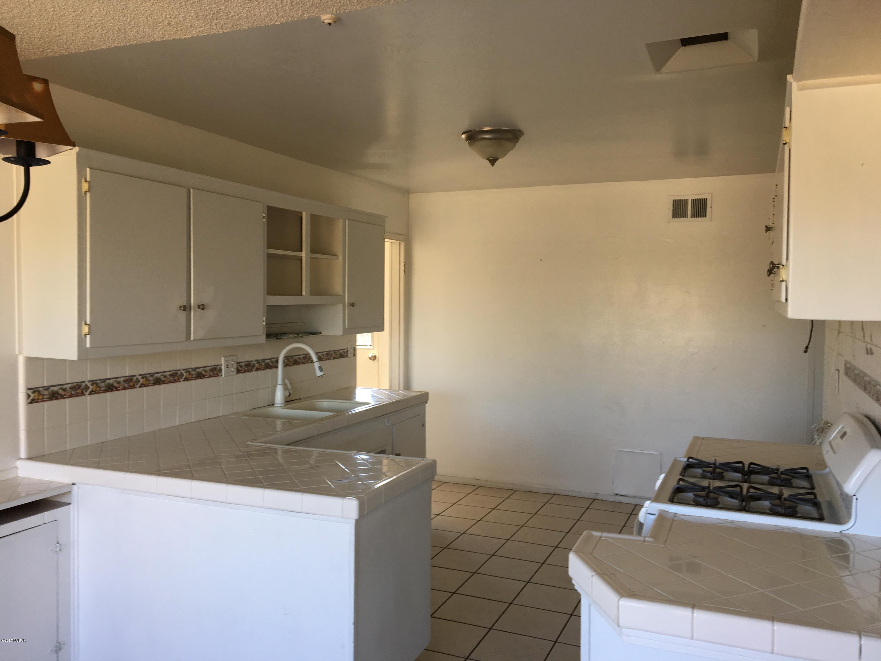 3407 Via Dona Lompoc, CA 93436 - Photo 6 of 11 a kitchen with granite countertop a sink a stove and cabinets
