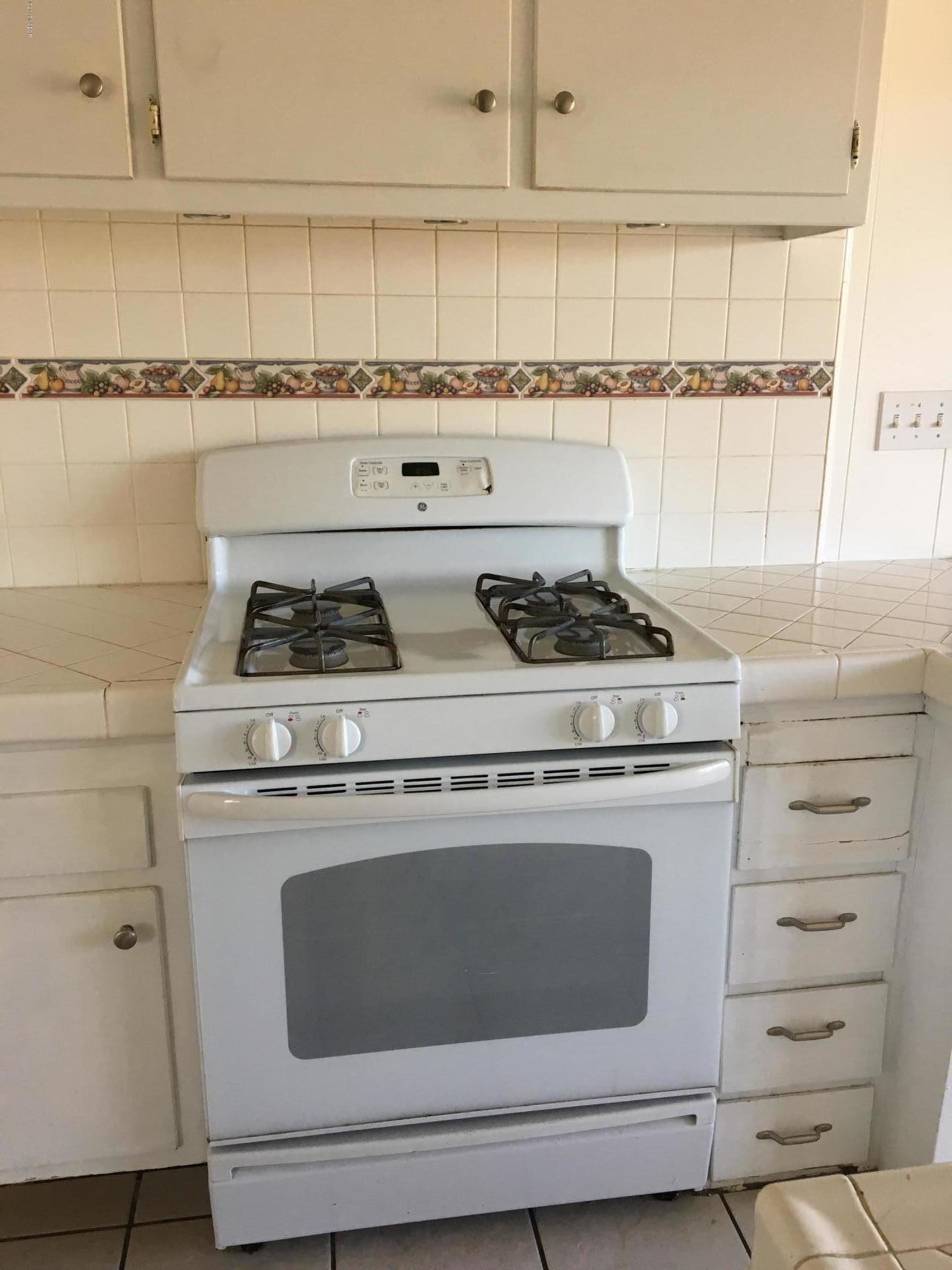3407 Via Dona Lompoc, CA 93436 - Photo 7 of 11 a stove top oven sitting inside of a kitchen