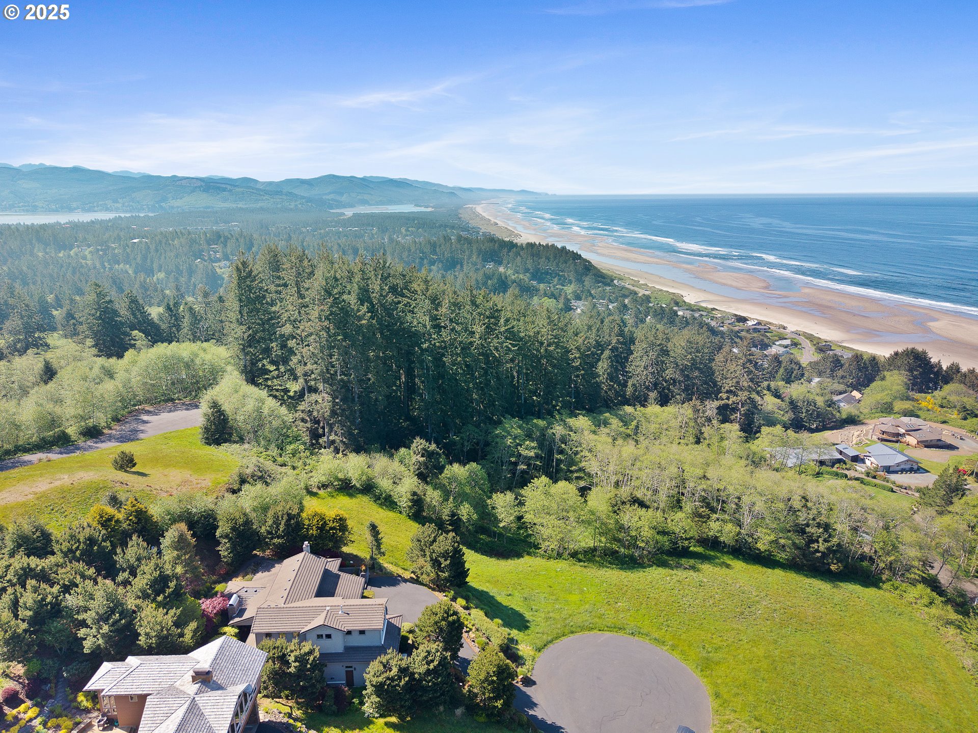 Tides Trail Nehalem, OR 97131 - Photo 7 of 16 a view of a city with mountains in the background