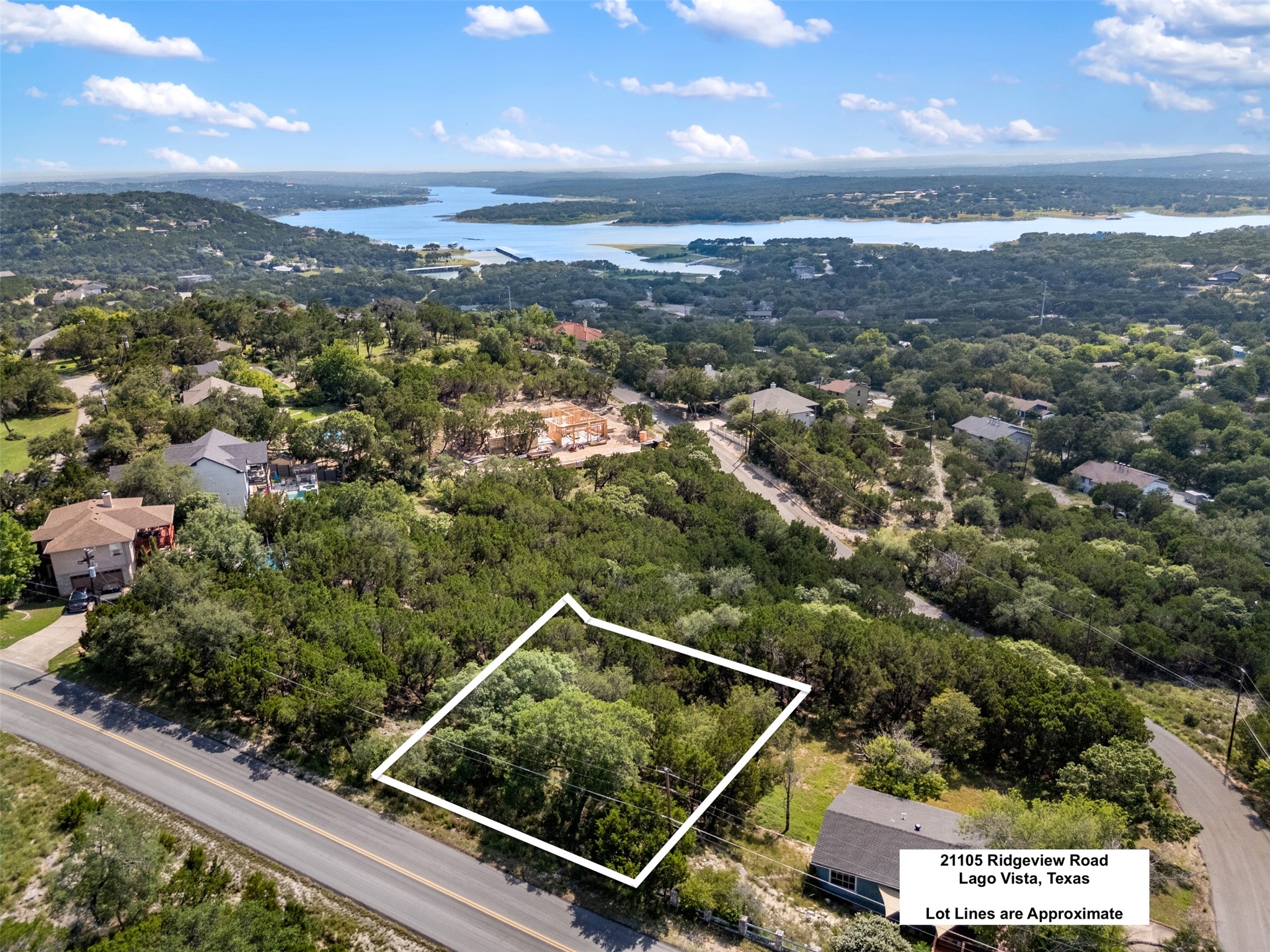 21105 Ridgeview Road Lago Vista, TX 78645 - Photo 6 of 34 Perched on a verdant hillside, this lot offers scenic vistas of the shimmering lake and surrounding natural beauty.