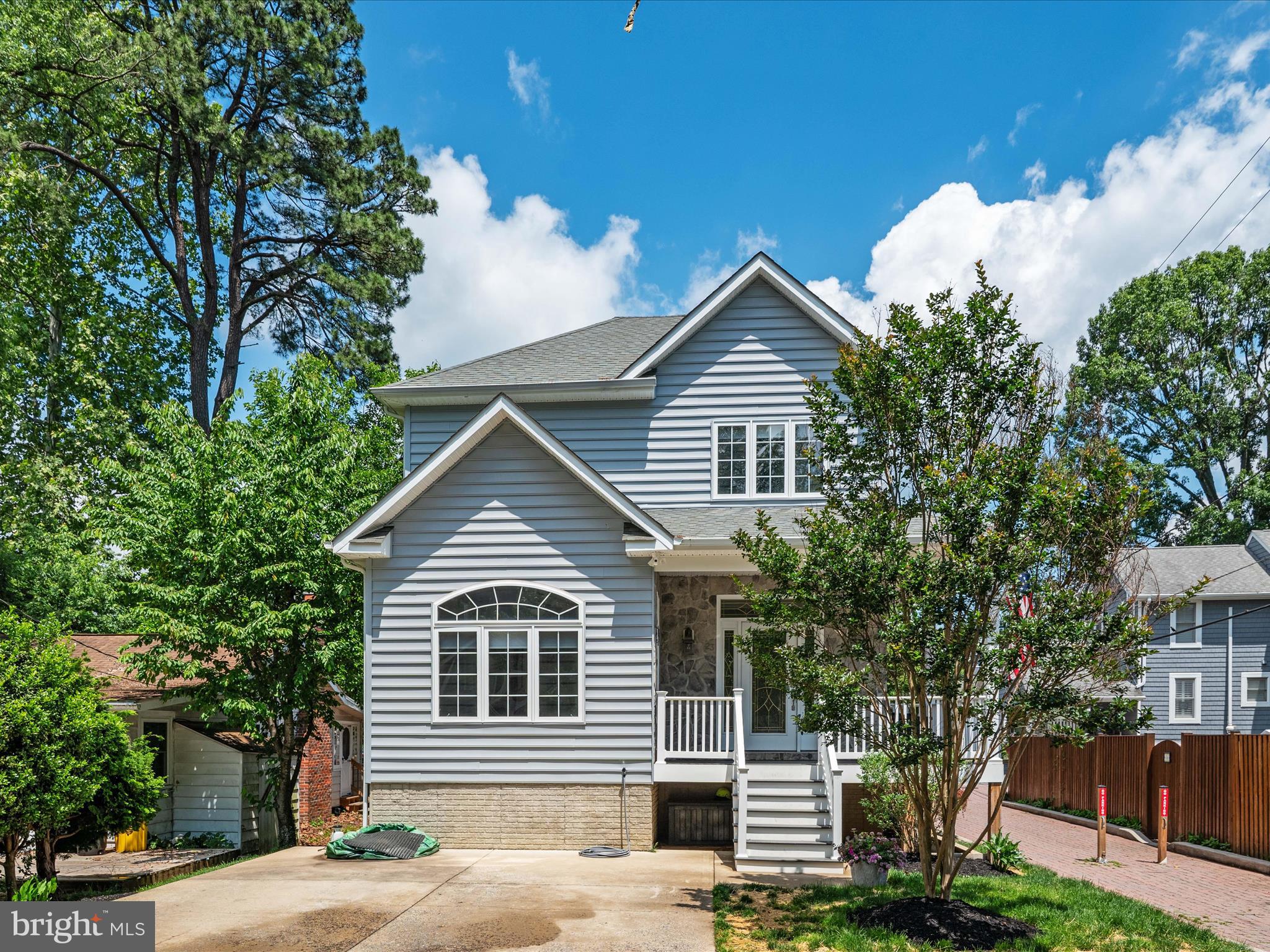 a view of a house with a yard and potted plants