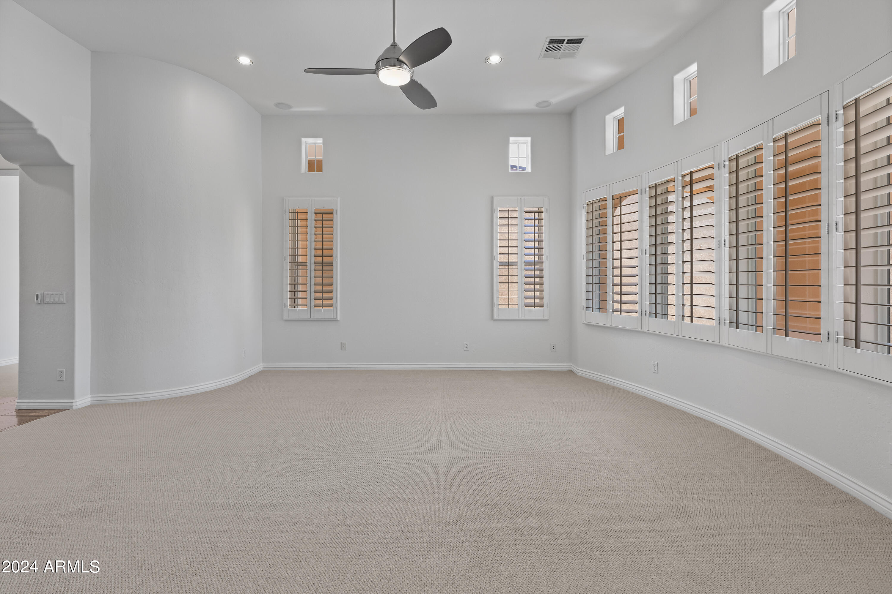 8883 East Mountain Spring Road Scottsdale, AZ 85255 - Photo 11 of 48 an empty room with windows and ceiling fan