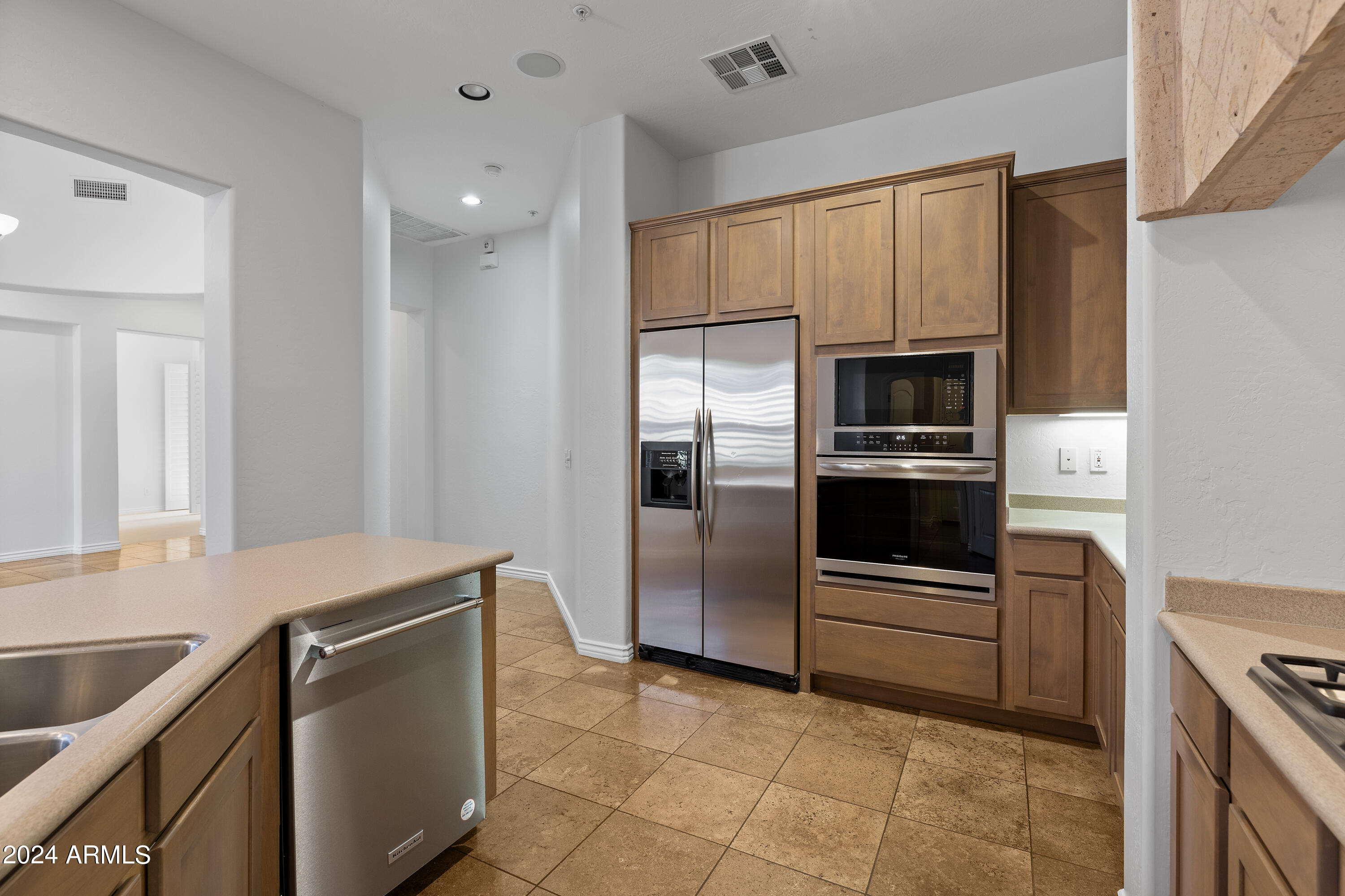 8883 East Mountain Spring Road Scottsdale, AZ 85255 - Photo 15 of 48 a kitchen with granite countertop a refrigerator and a stove