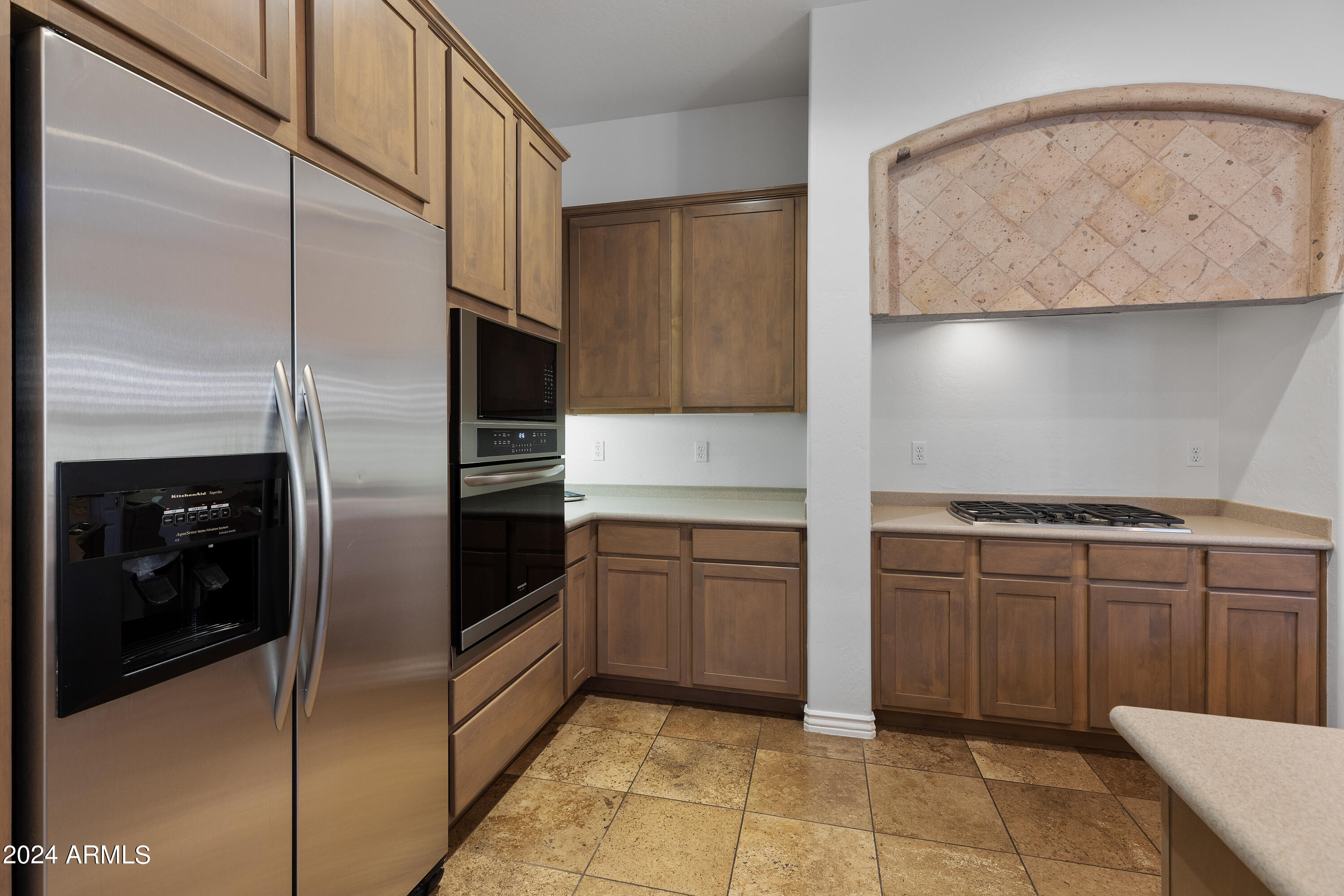 8883 East Mountain Spring Road Scottsdale, AZ 85255 - Photo 16 of 48 a kitchen with granite countertop a refrigerator and a stove