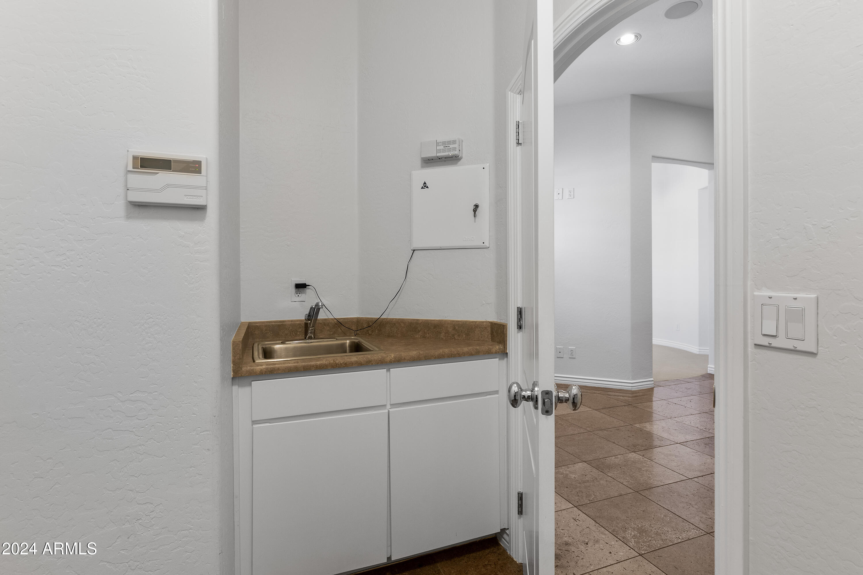 8883 East Mountain Spring Road Scottsdale, AZ 85255 - Photo 28 of 48 a bathroom with a granite countertop sink a mirror and vanity