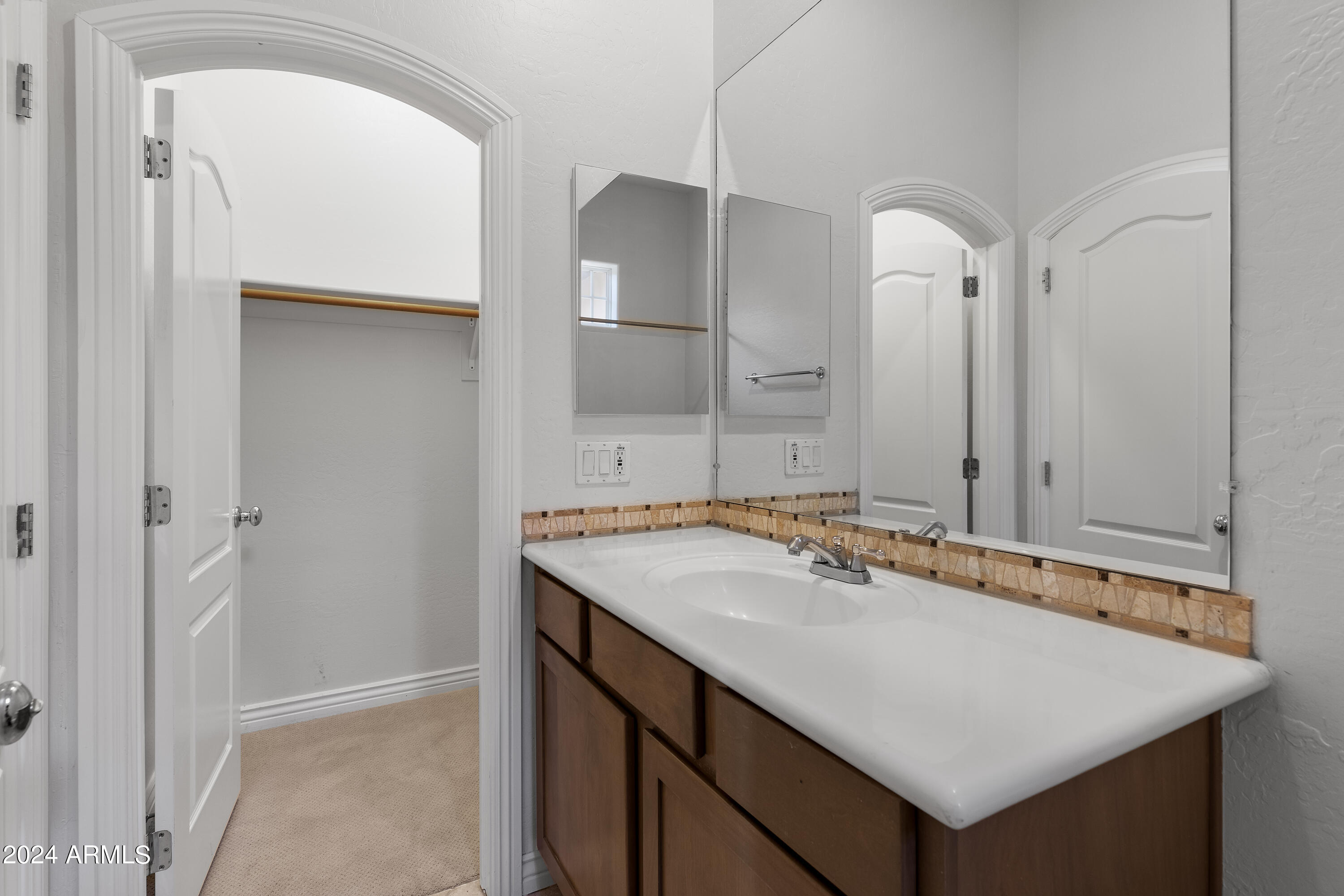 8883 East Mountain Spring Road Scottsdale, AZ 85255 - Photo 32 of 48 a bathroom with a sink vanity and a mirror
