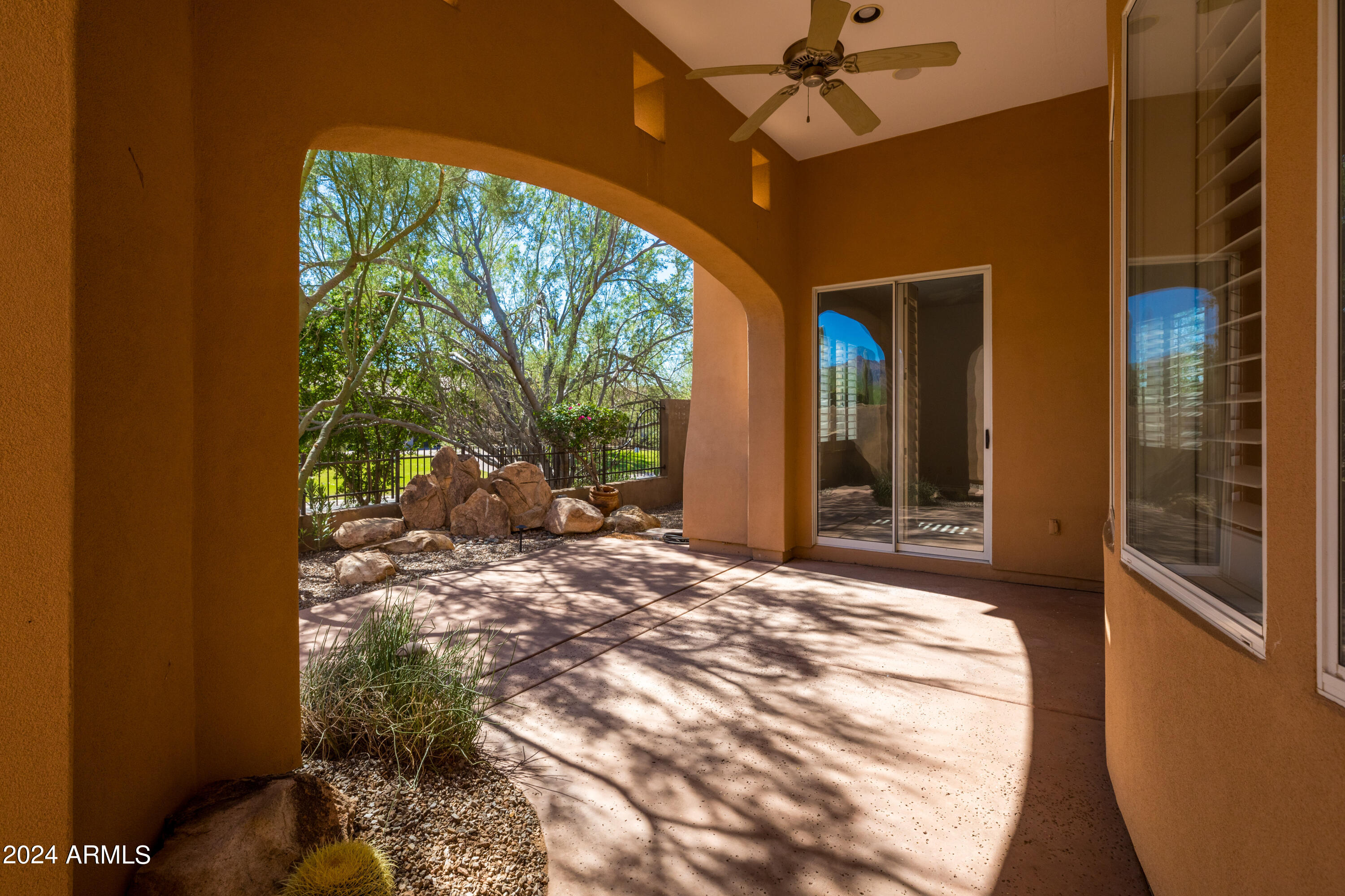 8883 East Mountain Spring Road Scottsdale, AZ 85255 - Photo 40 of 48 a view of a porch with a floor to ceiling window and an outdoor space