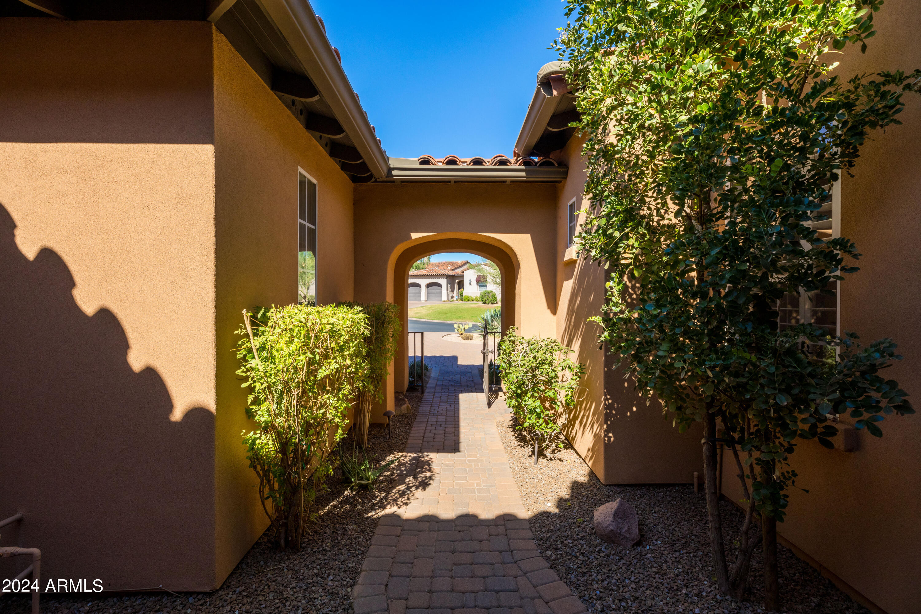 8883 East Mountain Spring Road Scottsdale, AZ 85255 - Photo 6 of 48 a front view of a house with lots of green space
