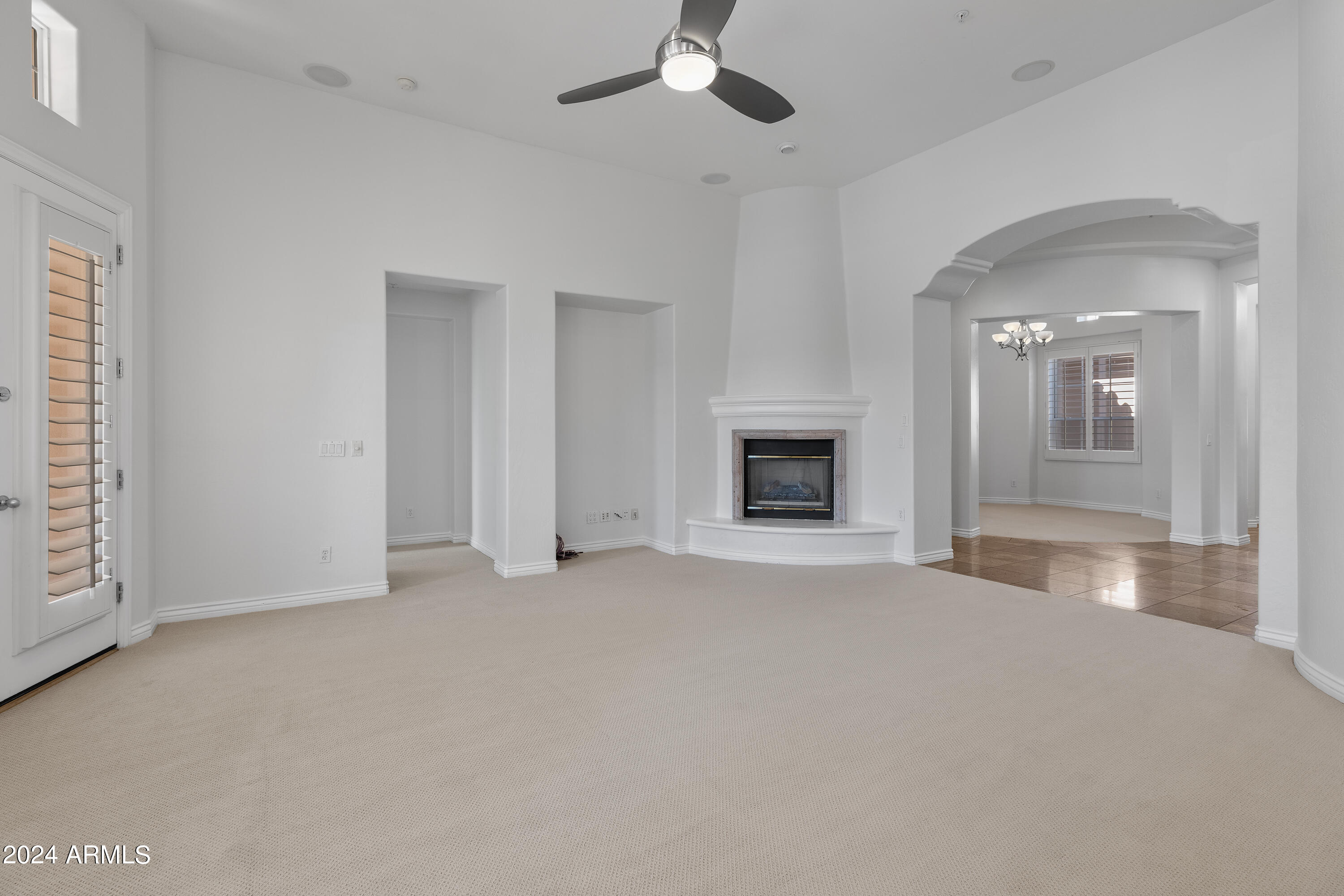 8883 East Mountain Spring Road Scottsdale, AZ 85255 - Photo 9 of 48 an empty room with windows and fireplace