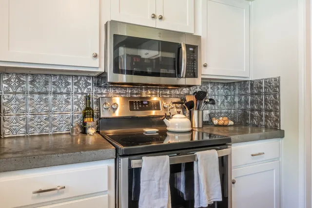 a kitchen with a sink and a stove with cabinets