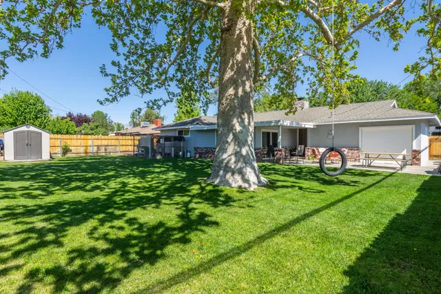 a view of a house with a backyard patio and a garden