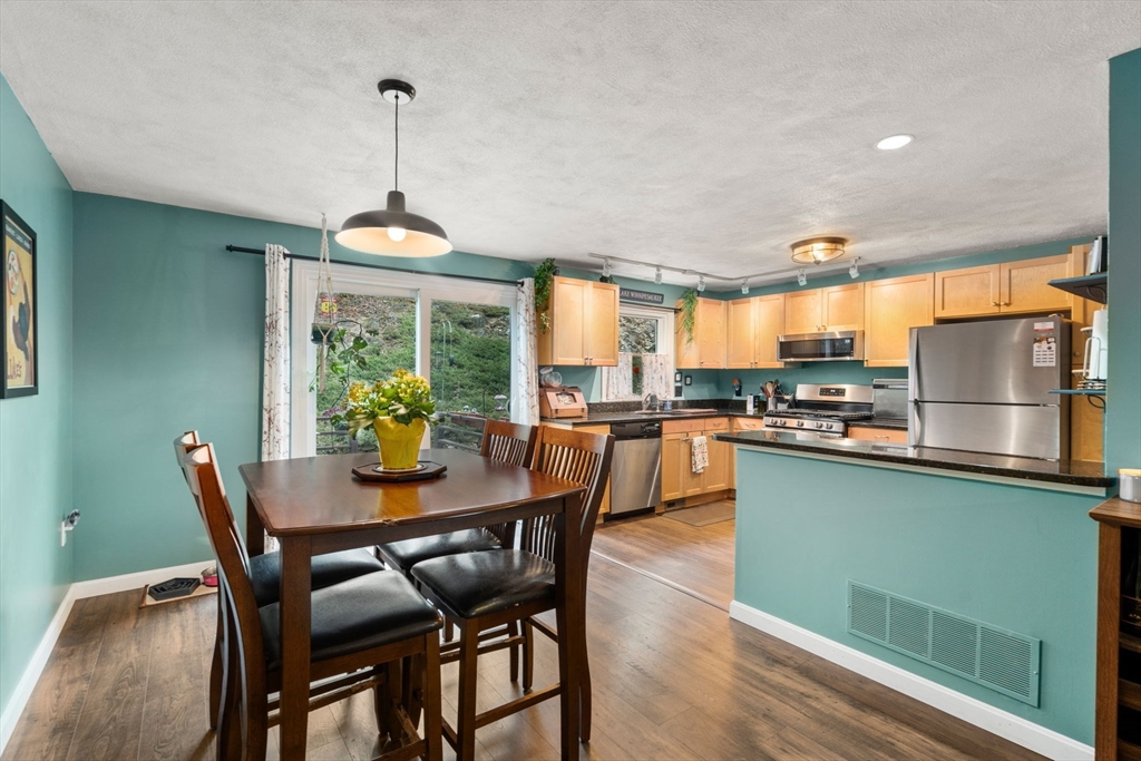 12 Oak Ridge Drive, Unit 3 Maynard, MA 01754 - Photo 7 of 34 a dining room with furniture a chandelier and wooden floor