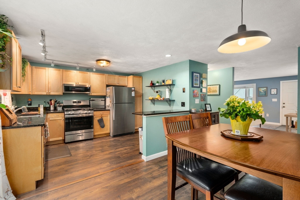 12 Oak Ridge Drive, Unit 3 Maynard, MA 01754 - Photo 8 of 34 a kitchen with stainless steel appliances dining table and chairs