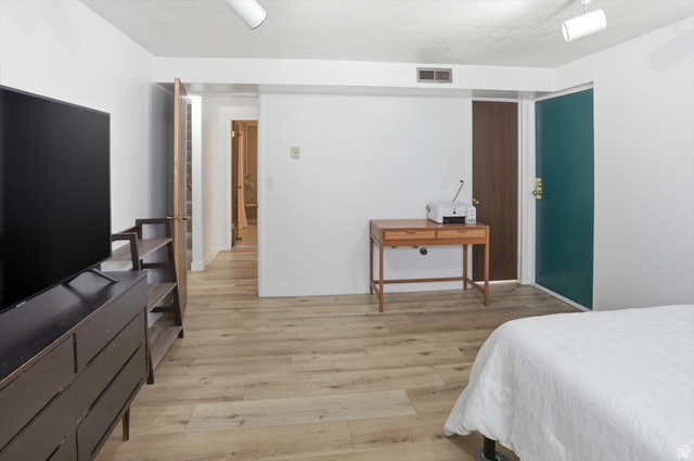 5108 South 2000th Street West Roy, UT 84067 - Photo 40 of 61 Bedroom with light wood-type flooring and a textured ceiling