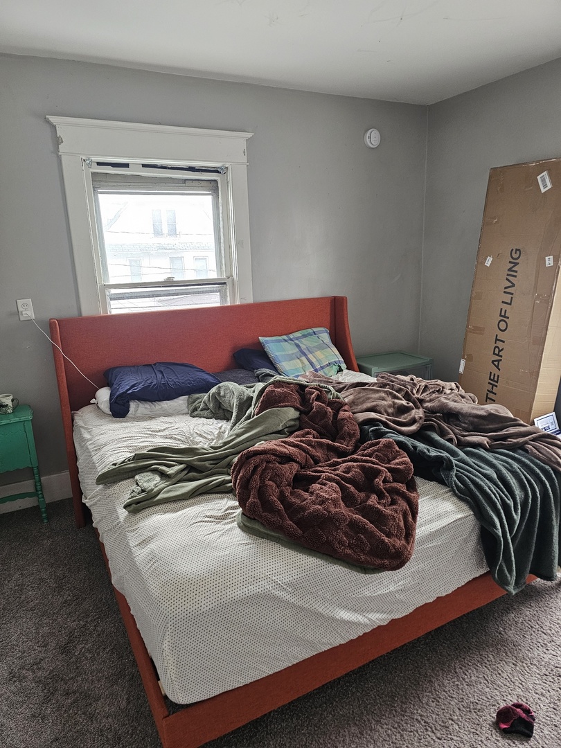 1115 14th Street Moline, IL 61265 - Photo 12 of 14 a bedroom with a bed and a window