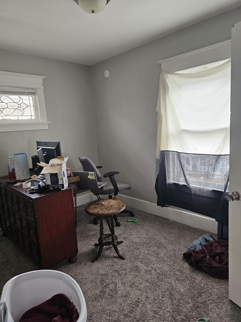 1115 14th Street Moline, IL 61265 - Photo 13 of 14 a living room with furniture a window and a lamp