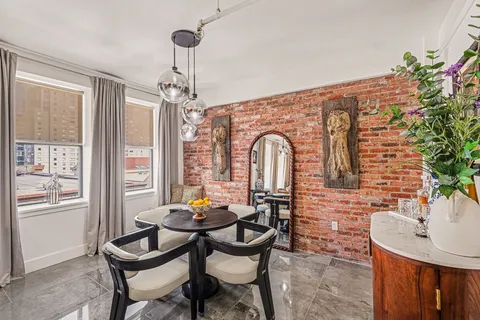 a view of a dining room with furniture window and outside view