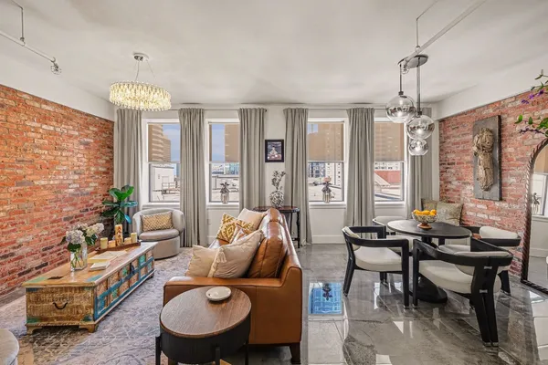 a living room with furniture and a chandelier