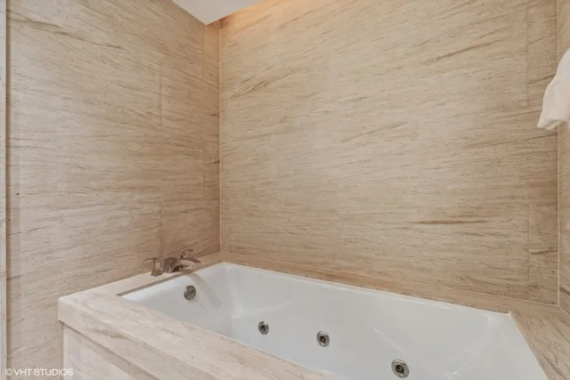 a bathroom with a tub and a shower