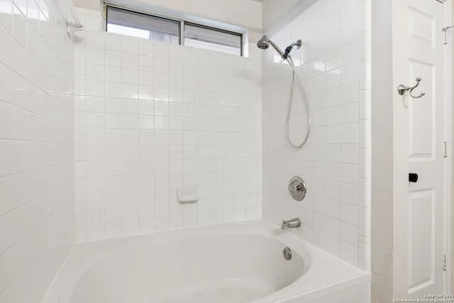 a bathroom with a shower and a bath tub