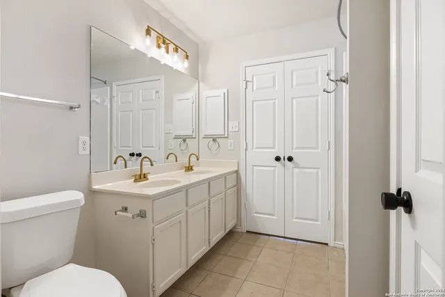 a bathroom with a toilet sink and mirror