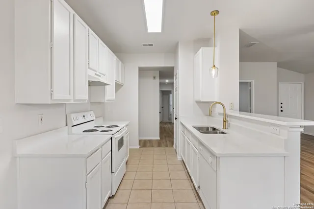 a kitchen with stainless steel appliances a sink stove and cabinets
