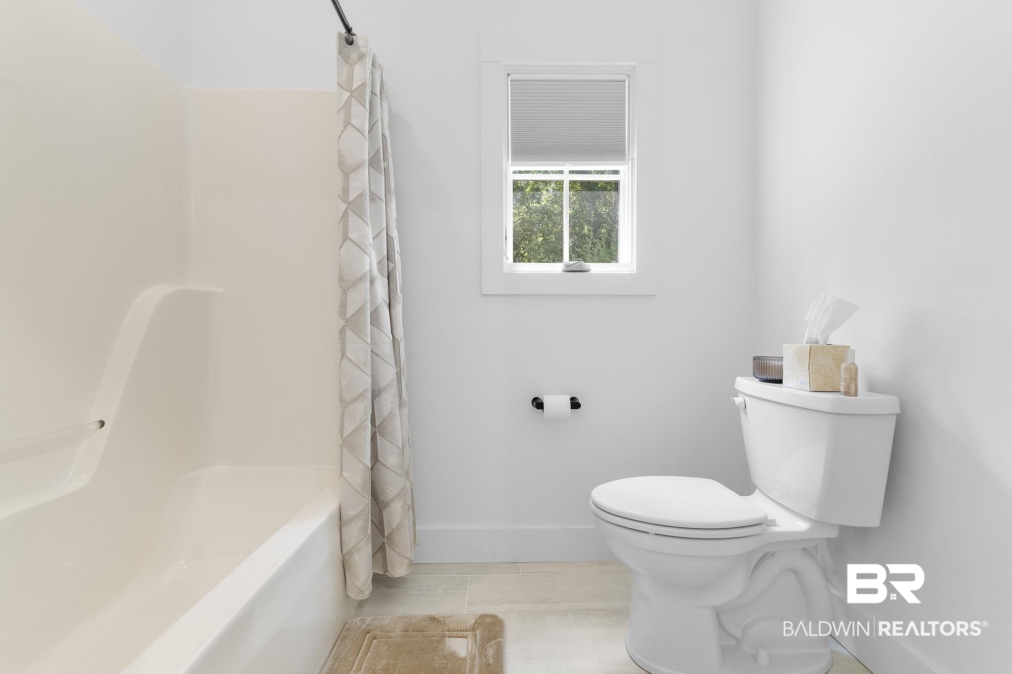 4451 Millhouse Road Gulf Shores, AL 36542 - Photo 37 of 50 Bathroom featuring tile patterned flooring, shower / bathtub combination with curtain, and toilet