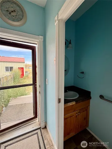 a bathroom with a granite countertop sink a toilet and bathtub