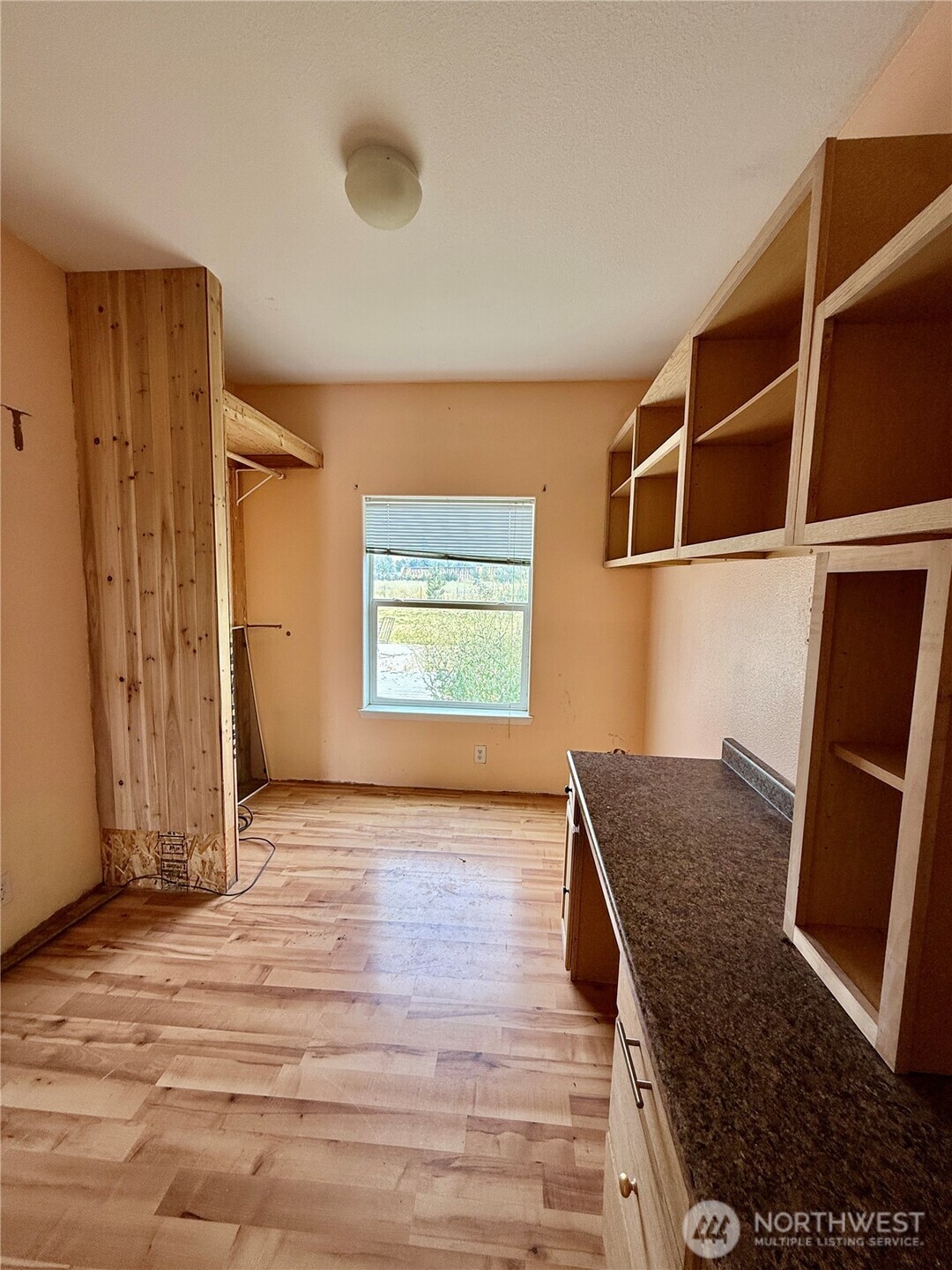 110 Main Road Dayton, WA 99328 - Photo 21 of 36 a view of an empty room with wooden floor and a window