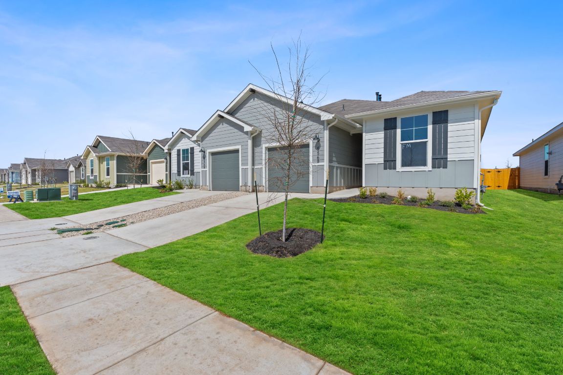 556 Arnold Loop, Unit B Kyle, TX 78640 - Photo 1 of 21 a front view of a house with a garden and yard