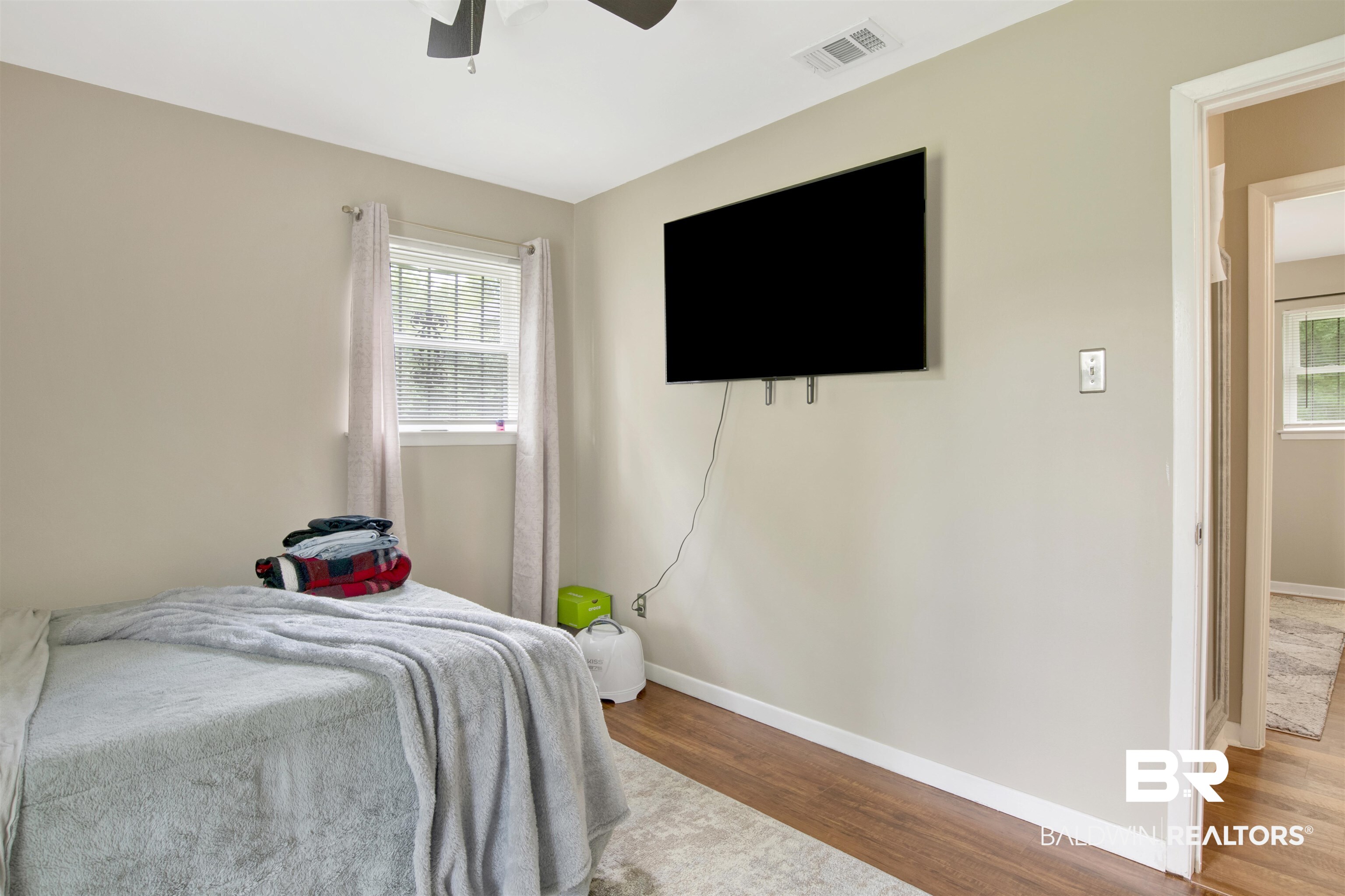 1476 Boudousquie Street Mobile, AL 36605 - Photo 21 of 34 Bedroom featuring wood finished floors and ceiling fan