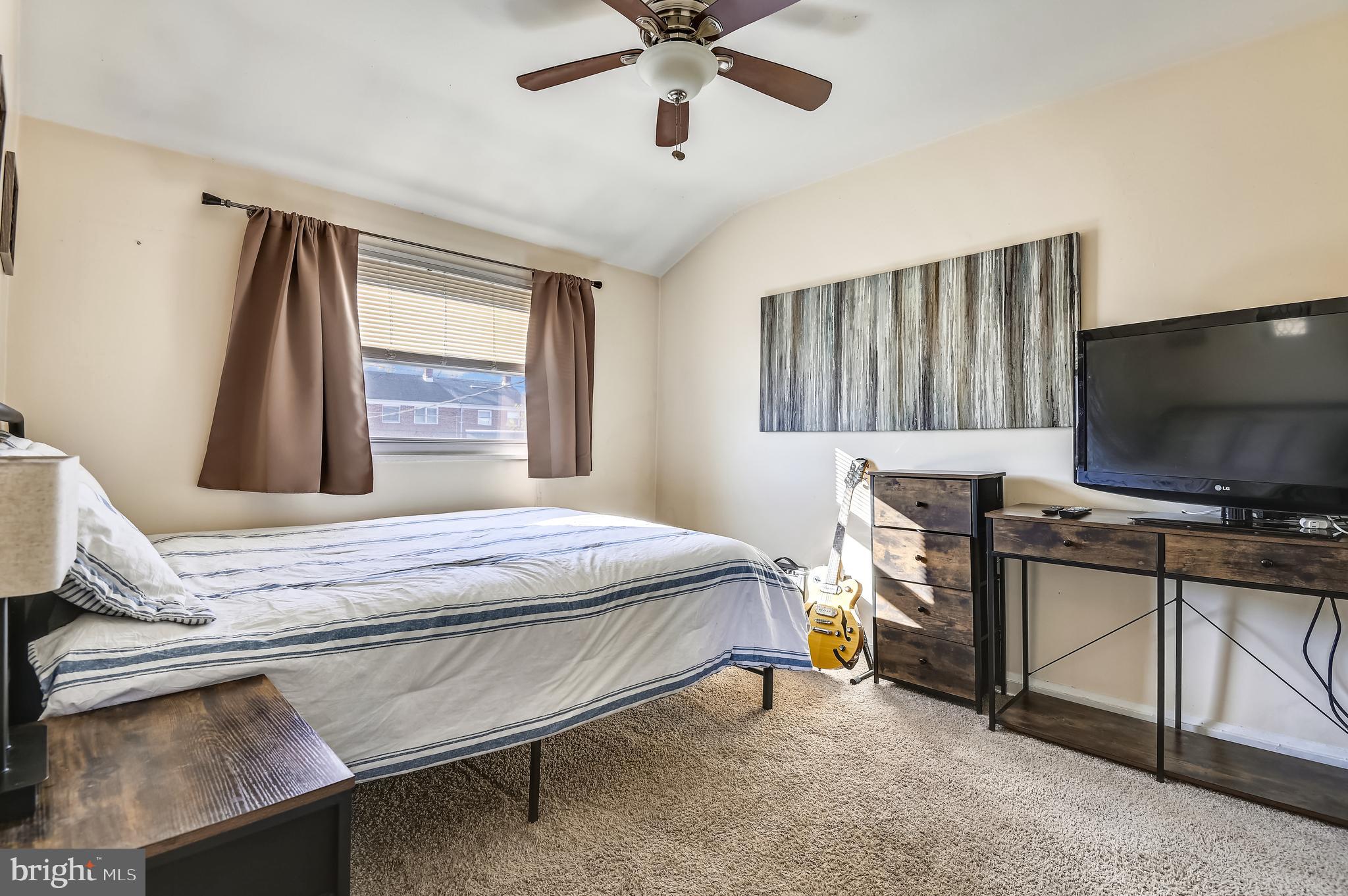 3409 North Point Road Dundalk, MD 21222 - Photo 27 of 36 a bedroom with a bed and a flat screen tv