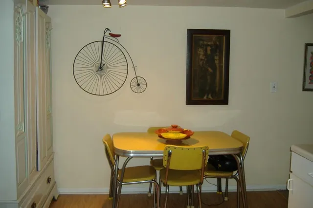 a dining room with furniture and wooden floor
