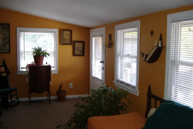 a view of a livingroom with furniture and windows