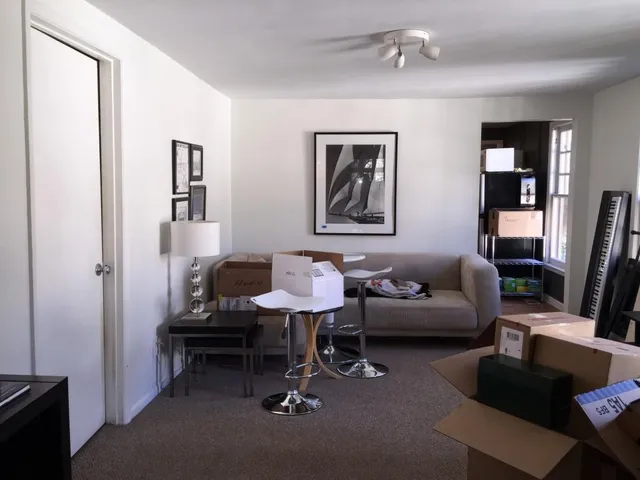a living room with furniture a window and a flat screen tv