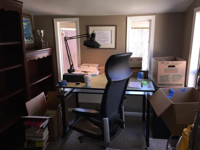 a work room with furniture and wooden floor