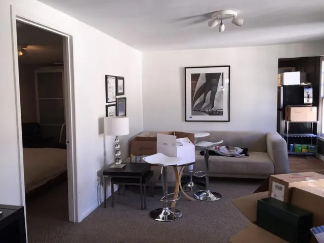 a living room with furniture and a lamp