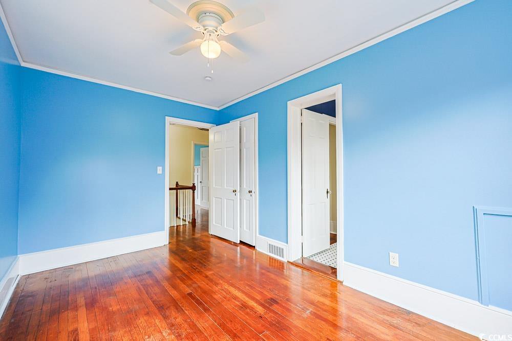509 Beaty Street Conway, SC 29526 - Photo 14 of 40 Unfurnished bedroom featuring hardwood / wood-style floors, a ceiling fan, and crown molding