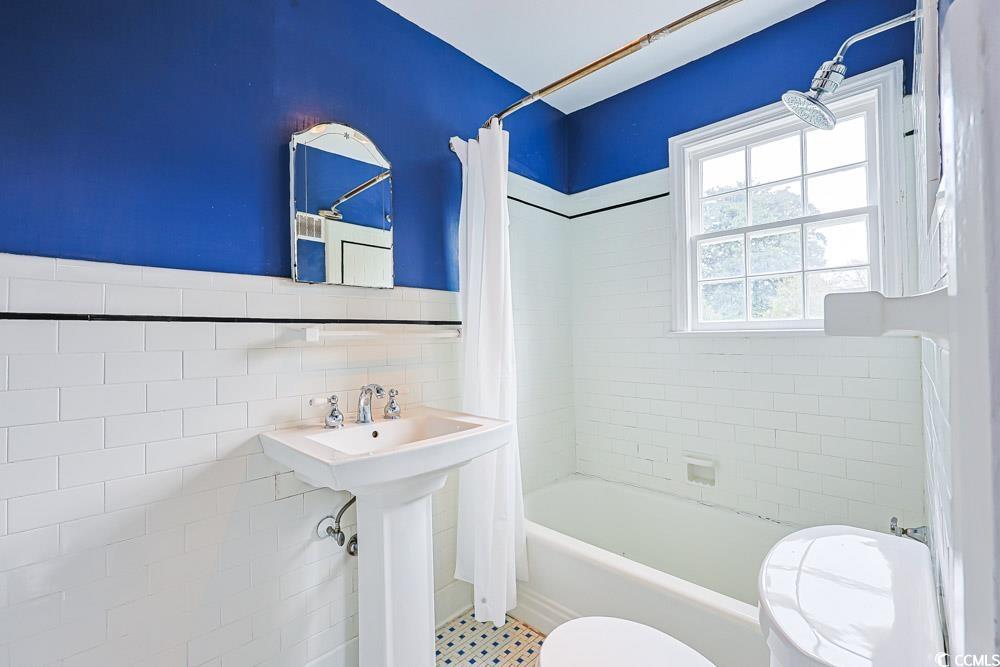 509 Beaty Street Conway, SC 29526 - Photo 16 of 40 Bathroom with shower / bath combination with curtain and tile walls
