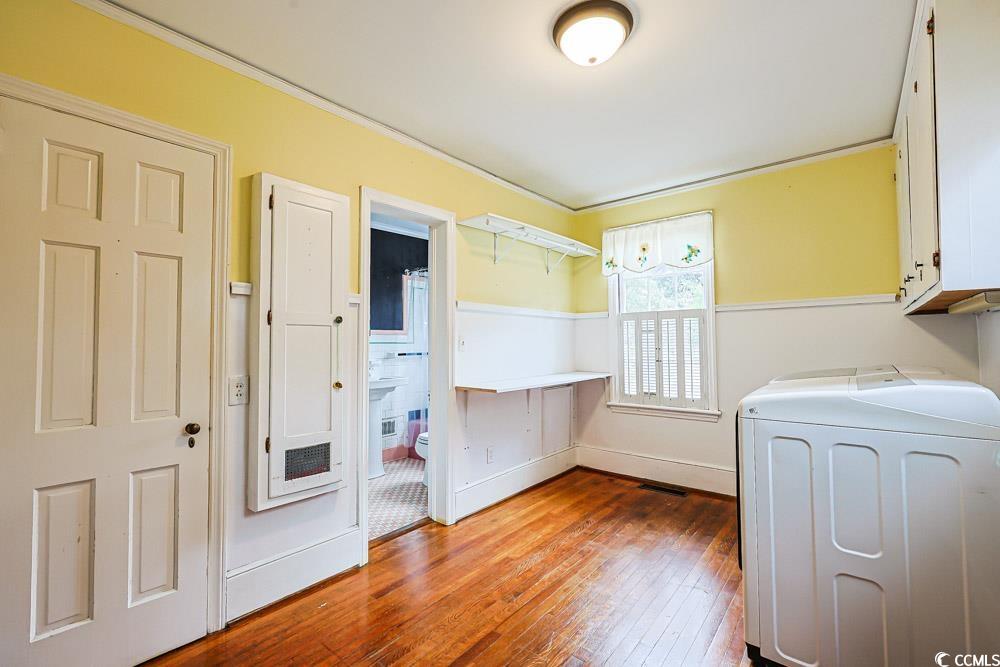 509 Beaty Street Conway, SC 29526 - Photo 26 of 40 Laundry room featuring light wood-style flooring, cabinet space, ornamental molding, and washer and clothes dryer