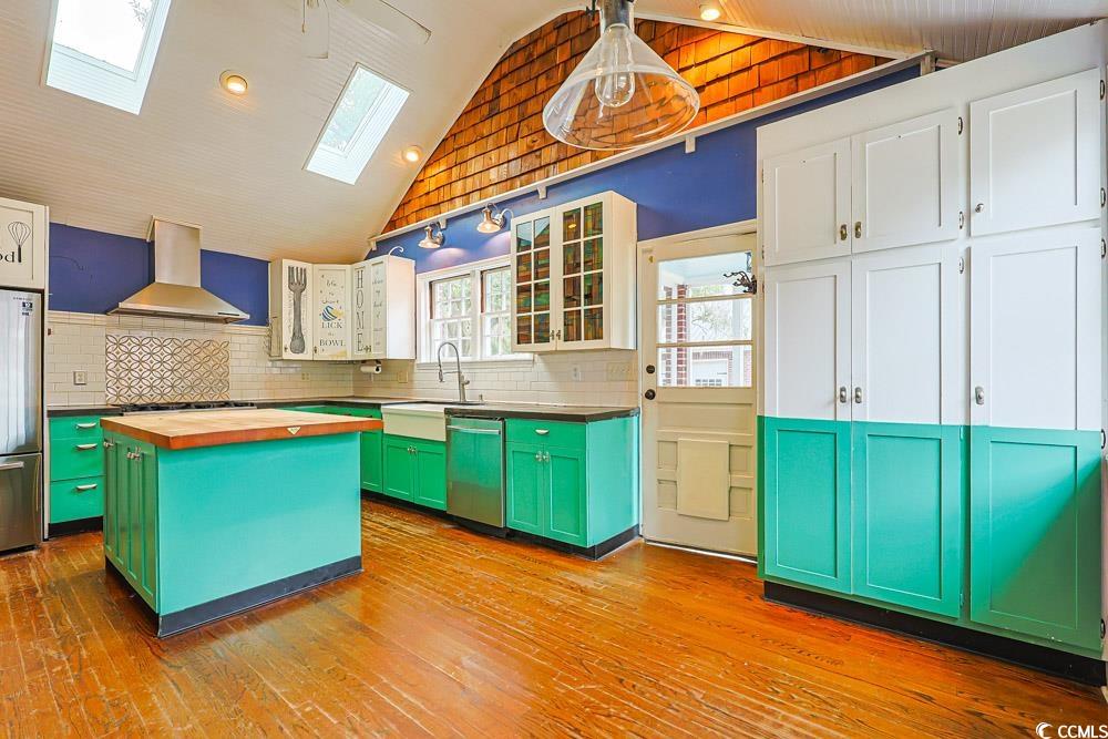 509 Beaty Street Conway, SC 29526 - Photo 8 of 40 Kitchen featuring green cabinetry, a center island, a skylight, wooden counters, and glass insert cabinets