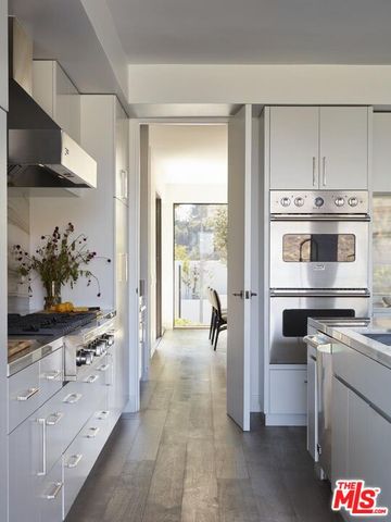 a kitchen with a stove and a refrigerator