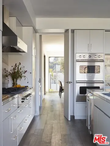 a kitchen with a stove and a refrigerator